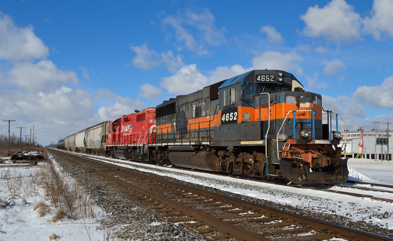 CP T76 led by ex B&M 4652 and ex D&H 7305 waits for its conductor to throw the east switch to get back on the main after allowing CP 254 to get ahead of him.