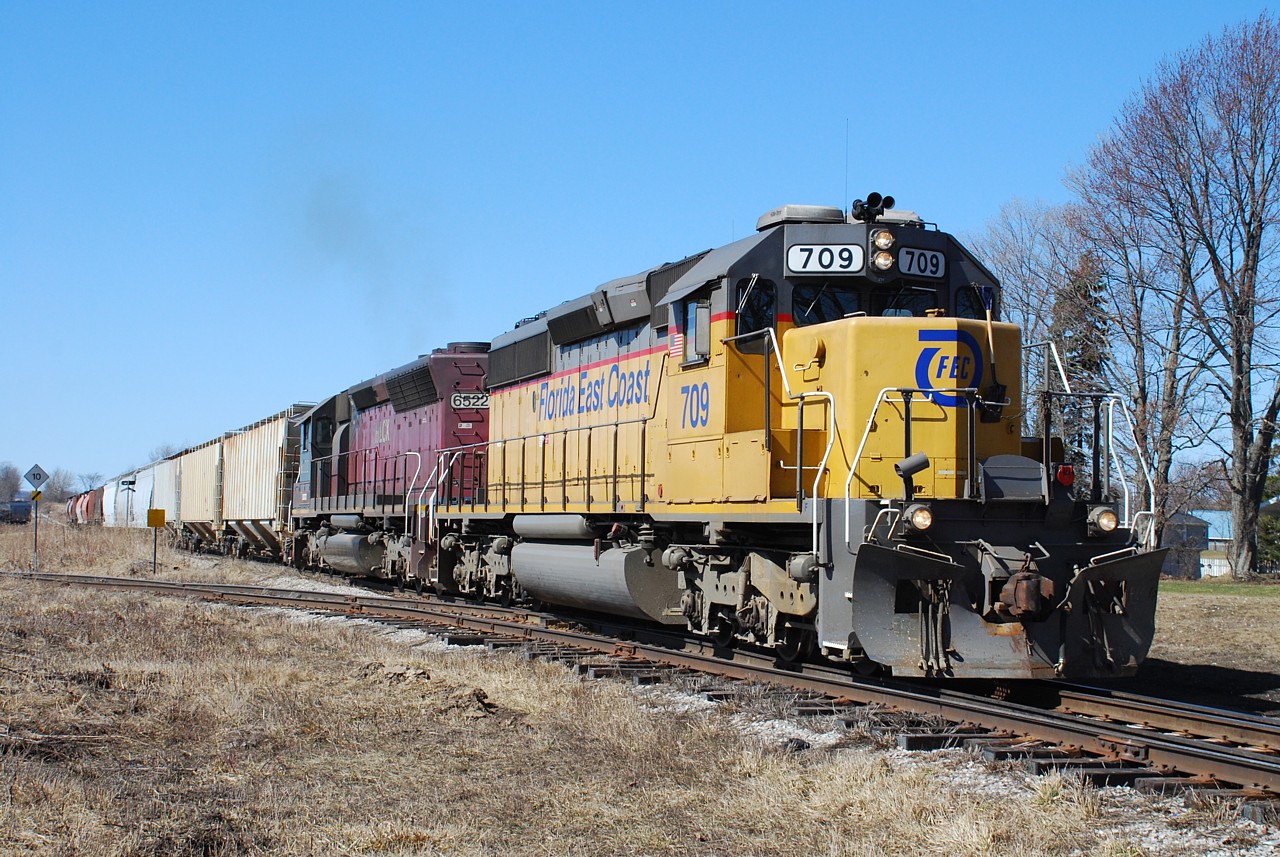 GEXR 581 finally departs Clinton after a lengthy stop to get HLCX 6522 restarted. Why a single SD40-2 couldn't handle the 13 car train is beyond me.