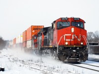A GP9 in intermodal service! CN 148 kicks up the fresh snow as it rolls through Brantford with CN 4130 trailing. The geep was repaired at Woodcrest Shop and was being transferred back to Mac Yard. 