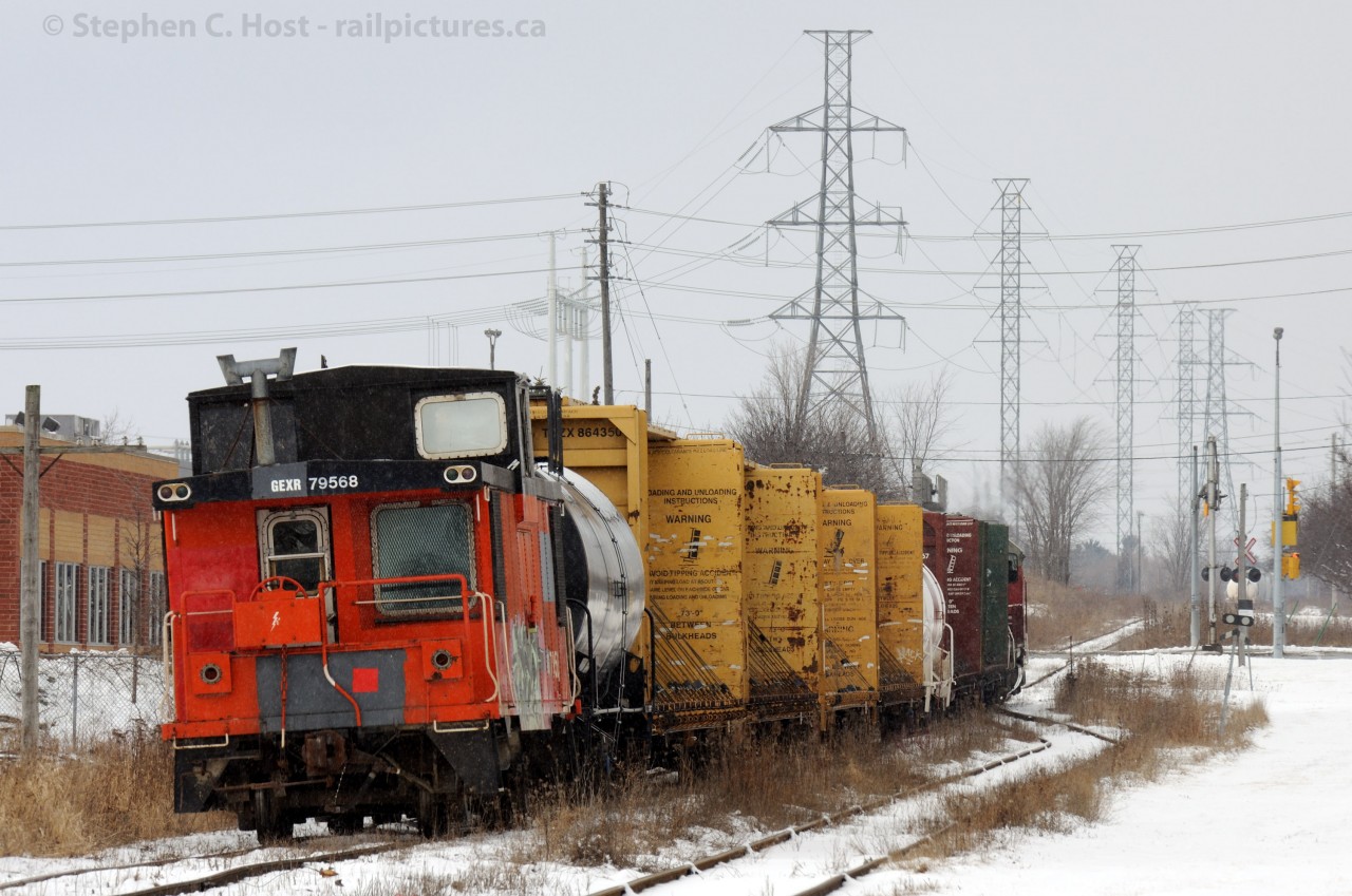Caboose:  GEXR 582 trundles north on the former CN Fergus Sub (Ends 1/3 mile north of photo) with a Caboose - GEXR 79568 bringing up the rear. Until 1970 this line hosted Passenger trains (ending as RDC's) and from 1970 to 1975 or so 80 car bunker C oil trains (Pix anyone?) ran up this line to Palmerston and Douglas Point. The line north of Fergus was abandoned by 1982 and Guelph to Fergus in 1988. This section survives as GEXR's connection to the OSR and the joint industrial track served by both GEXR and OSR.