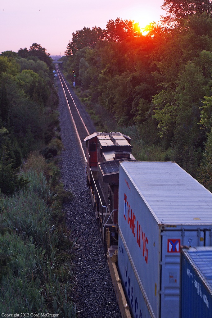 Very Early and with a single unit 106 heads into a sunrise approaching the Kingston Sub in Pickering Ontario.