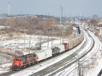 A CN Oakville to Aldershot transfer job is about to pass the new GO Transit parking garage at Oakville's GO/VIA station.