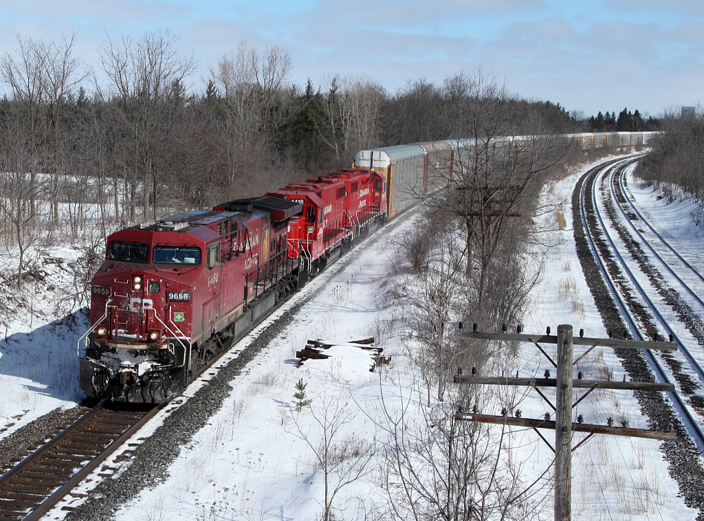 CP 235 flies around the curve at Lobo with two freshly rebuilt ex-SOO GP38-2s giving their all.