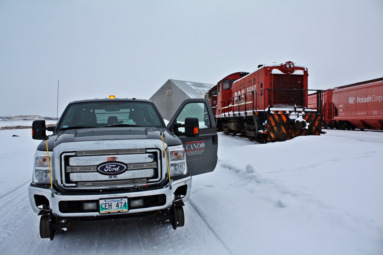 My company Hi-rail used out at PCS Rocanville for patrolling the yard sits parked for a shot beside the dead and drained SW8/SW9 units that have been replaced by two tunnel motors. Well for these old units they almost made another year of active service just shy of a month.