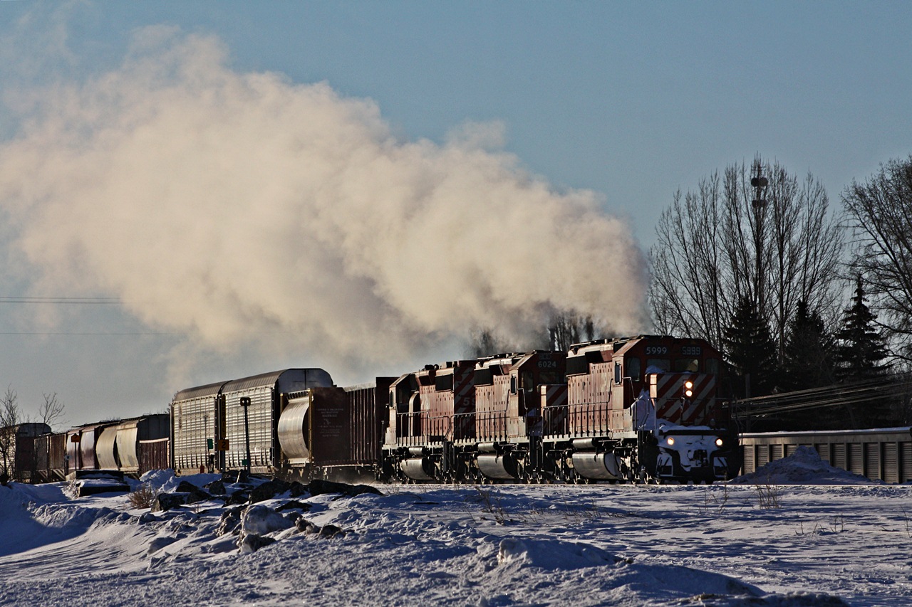 CP 411 with a trio of SD40-2's throttle up out of the siding at Virden MB for a meet with a 674 potash train. The temperature with the windchill was -42 and boy these units were a howling.