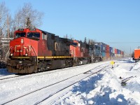 CN train 107 glides through Auden, ON with Montreal-Toronto-Winnipeg stacks. The machine I operate is tucked away in the Auden spur.