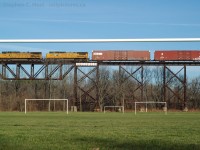 Framed in the goalposts of the St. Thomas "Athletic Park" soccer field, Norfolk Southern train 327 (Buffalo to St. Thomas) is running across the "Wabash Tresle" as the locals call it, as they have done for nearly 109 years. The train is en-route to Talbotville yard with fresh loads of stamped automotive parts from the Ford Buffalo Stamping Plant. Two years prior were the last runs of NS 343 and 344 (St. Thomas to Detroit) which ran across this very tresle. In 10 days the last NS train would run to St. Thomas and today, this line is as good as abandoned with only the elevator at Paynes getting rail service. This line is not likely to survive as CN had listed it for discontinuance/abandonment in 2012.