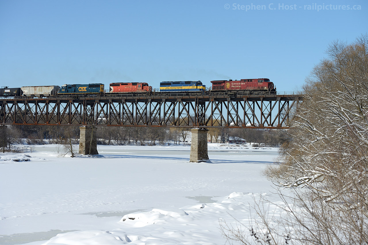 A loaded Ethanol train heads across the Grand River at Galt, Ontario with a couple visitors from the US.