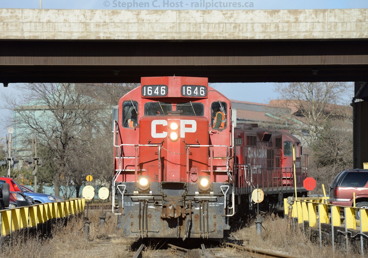 Bayfront:  CP's Belt Line job, emerging from underneath the Burlington St. Elevated roadway on the Dofasco Bayfront Lead - has just pulled a cut of cars from National Steel Car (Autorack frames) and will deposit them in the former TH&B Adams Yard.