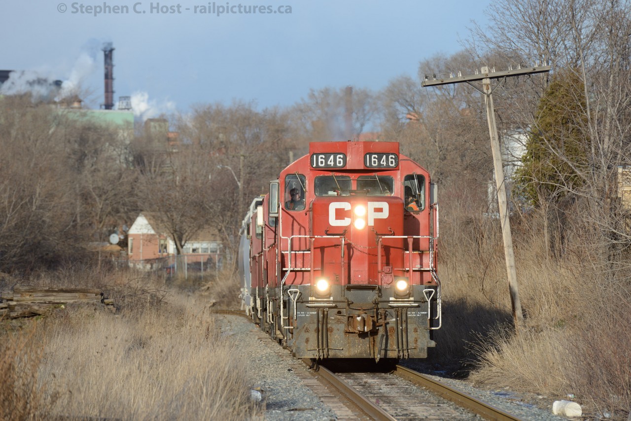 Belt Line: The former TH&B Belt Line has seen upgrades recently, with the laying of welded rail on almost half of the line. Here CPR's Belt Line job is emerging out of the CPR/CNR underpass and grade with three plastics hoppers, about to hit Barton Street and leave North Hamilton.