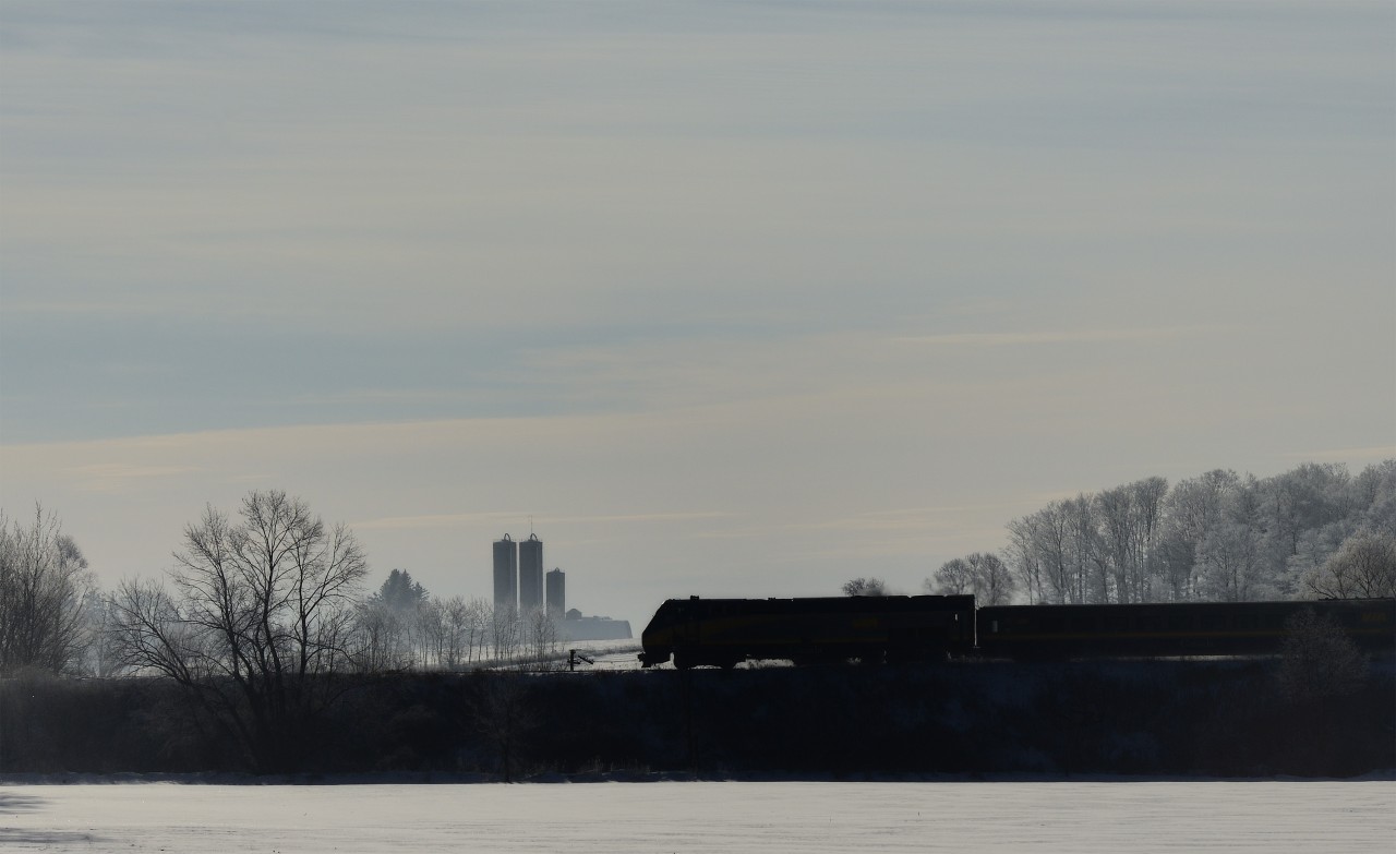 Hoarfrost - VIA 84 passing through Mosborough, Ontario on a crisp, cold February morning. Hoarfrost has coloured the background forests a glimmering white while the winter sun  tries dearly to warm the air in vain.