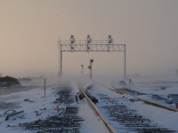 On a cold, snowy New Year's Eve day, the former searchlight signals guarding the east siding switch of Wolverton siding on the Galt Sub are dwarfed by the brand-new signal bridge guarding what is now "East Begin/End CTC Sign Wolverton (WOL)." Can someone comment on the positioning of the searchlights. Older pictures revealed that the double signals were closer to the road behind me.