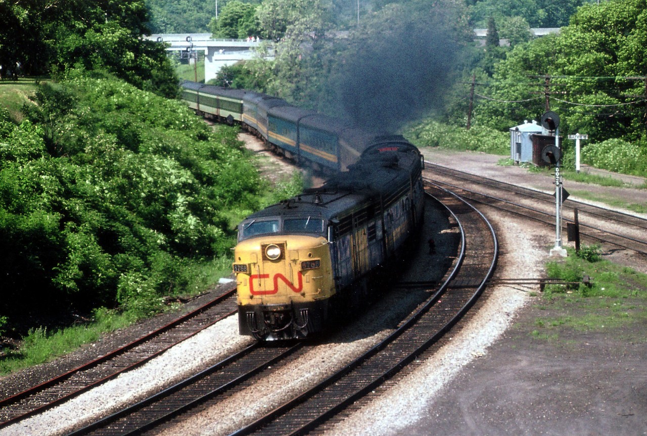 An early VIA paint scheme on 6768 is evident on this smoky version of CN passenger train #75 heading west thru Bayview Junction on a late July afternoon in 1978. I'd like to assume these units had "CN" on the nose because VIA had not yet come into being even though a lot of painting had been ongoing in preparation for the official start-up come October. There were many other variations of "Noses" for a few years at this time, ranging from standard CN colours with the 'CN' painted out, or 'CN' left on,to red VIAs on yellow, yellow noses with no ID,yellow nose lines slanted rather than squared off at the sides, blue VIA on nose, and of course experimental 6532. Passenger trains were actually interesting back then.