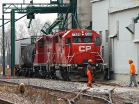 DERAILMENT! Here we see CP Chatham Local T76 on the ground in Kent Bridge at the Thompson's Co-Op facility. As 7309 and 8200 serviced the grain elevator the rails slipped out from beneath 7309's front truck and rolled the North (far side) rail causing a violent rocking with the locomotive slamming up against the side of the building before righting itself. Crews spent several hours assessing the situation and the locomotive remained like this for several days I've been told. 8200 later ran light back to Windsor without 7309.