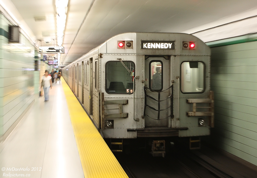 Having just made its brief station stop, TTC "T1" subway car 5116 trails on a westbound train bound for Etobioke, zipping out of the lower levels of the St. George Subway Station on the Bloor-Danforth line. She's likely been ping-ponging between Kipling and Kennedy all day, and will continue to do so into the wee hours of the next day.