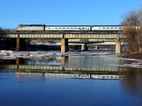 VIA's westbound Canadian crosses the Assiniboine River in downtown Winnipeg. The train is returning two Rocky Mountaineer coaches back to Kamloops, the cars were sent to Toronto for maintenance.