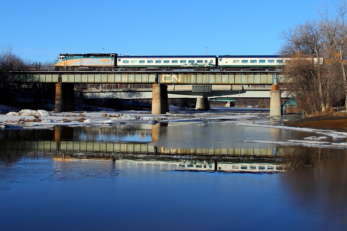 VIA's westbound Canadian crosses the Assiniboine River in downtown Winnipeg. The train is returning two Rocky Mountaineer coaches back to Kamloops, the cars were sent to Toronto for maintenance.