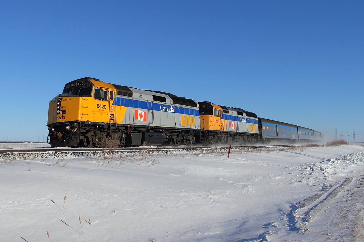 VIA's 693 Winnipeg to Churchill train heads out across the frozen prairie just west of Winnipeg.