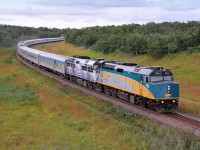 VIA's eastbound "Canadian" departs Rivers bound for Winnipeg. The second unit still wears the "Coors" livery.