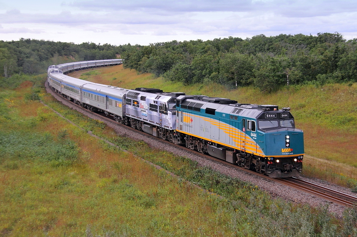 VIA's eastbound "Canadian" departs Rivers bound for Winnipeg. The second unit still wears the "Coors" livery.