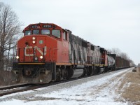 CN 439, with CN 4791 & 4774, and about 30 cars, heads down the VIA Rail Chatham Sub, at Wallace Line. You can see the Ties lined up along the side of the mainline for a Tie project that started late in 2012 and was put on hold for the Winter, and will start up in the Spring time. At this location, Freights can go 60 MPH, and Passenger trains can go 90 and LRC Speeds is 100 mph...