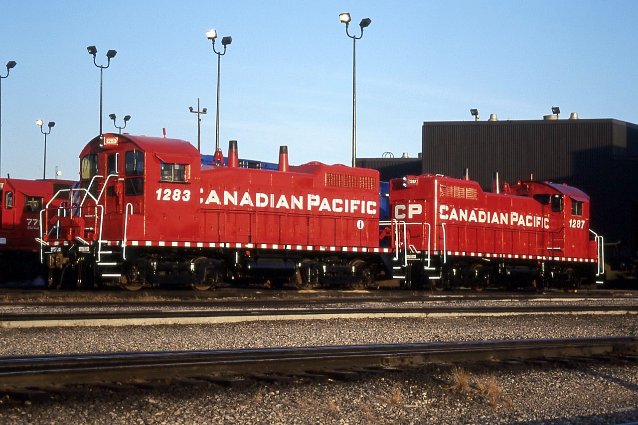Two of the three ex. UP SW10's that got repainted before CP pulled the plug on the project sun themselves outside the diesel shop at Alythe Yard.