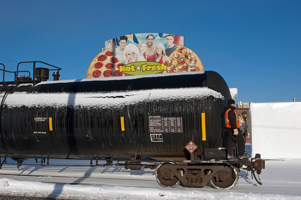 The loads aren't that hot, but they sure are fresh......a CP yard crew protects their movement as it passes the headquarters of the Pizza Pizza chain.