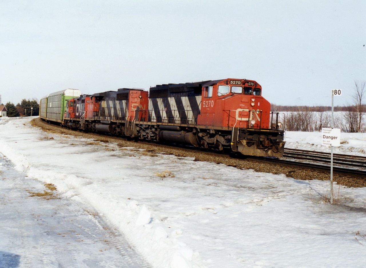 CN 305 speeds through the town with horns blaring.