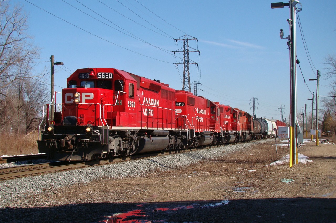 Four red EMD's lead a US-bound mixed freight through Lakeshore junction while Homeland Security keeps a close eye on Me.