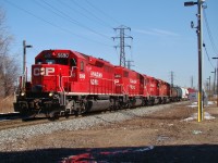 Four red EMD's lead a US-bound mixed freight through Lakeshore junction while Homeland Security keeps a close eye on Me.