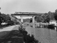 
VIA Rail train #9 at the Pointe au Baril bridge, Mile 48.5 Parry Sound Subdivision.
<br>
<br>
The classic A-B-B  GMD built F unit lashup was common during the summer season.
<br>
<br>
August 4, 1985 negative by S. Danko.
<br>
<br>
 <a href="http://www.railpictures.ca/?attachment_id=8958"> same train: tail end # 9 </a> 

