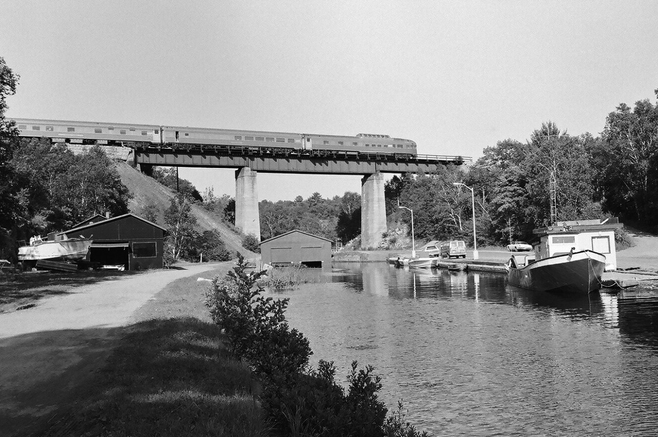 The Chateau sleeping car, Dining Room Car and Park car on VIA Rail train # 9 at the Pointe au Baril bridge, Mile 48.5 Parry Sound Subdivision. 


Reportedly VIA placed the Dining Room Car next to the Park to discourage coach passengers (coaches at the front of the train) from monopolizing the formal dining facilities. 


August 4, 1985 negative by S. Danko.