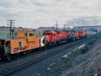  M for Magnificent.
<br>
<br>
On a cool, breezy and mainly cloudy early April 1980 Saturday a typical uninteresting Galt Subdivison afternoon, developed into an Alcophile's delight.
<br>
<br>
On the approach to Campbellville - on the grade up the Escarpment - CP Rail extra 4723 west ( with 4550 ) stalled when #4723 shut down. With 4723's train blocking  level crossings and with CP 4710 west following closely, extra 4723 west was unable to double the hill. ( At this time it was ABS territory, CTC to be installed at a later date ). Westbound 4710 ( with 4727 – 4717 ) crew cut off their train – near Hornby – running light to extra 4723 west's caboose ( #434525 ), coupled on and after some radio chatter commenced pushing extra 4723 west up the hill through Campbellville onto Guelph Junction. Second shot in the sequence of four, near Canyon Road. April 1980 Kodachrome by S.Danko.
<br>
<br>
 More big M's  at work :
<br>
<br>
 <a href="http://www.railpictures.ca/?attachment_id=8395"> at Campbellville </a> 
