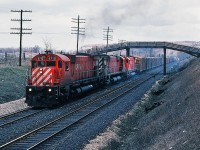  M for Magnificent.  CP Rail 4710 west has its own train in tow as it storms the hill up to Guelph Junction. The 4710 - 4727 – 4717 M636 trio completes the third pass of this day after providing Push Service for Extra CP Rail 4737 west. Fourth shot in the sequence of four, near Canyon Road. April 1980 Kodachrome by S.Danko.
<br>
 Big MLW 's  at work :
<br>
<br>
 <a href="http://www.railpictures.ca/?attachment_id=8750"> extra 4723 west </a> 
<br>
<br>
 <a href="http://www.railpictures.ca/?attachment_id=8749"> the big M pushers </a> 
<br>
<br>
 <a href="http://www.railpictures.ca/?attachment_id=8760"> more big M pushers </a> 
<br>
<br>
<a href="http://www.railpictures.ca/?attachment_id=1759"> the biggest big M </a> 