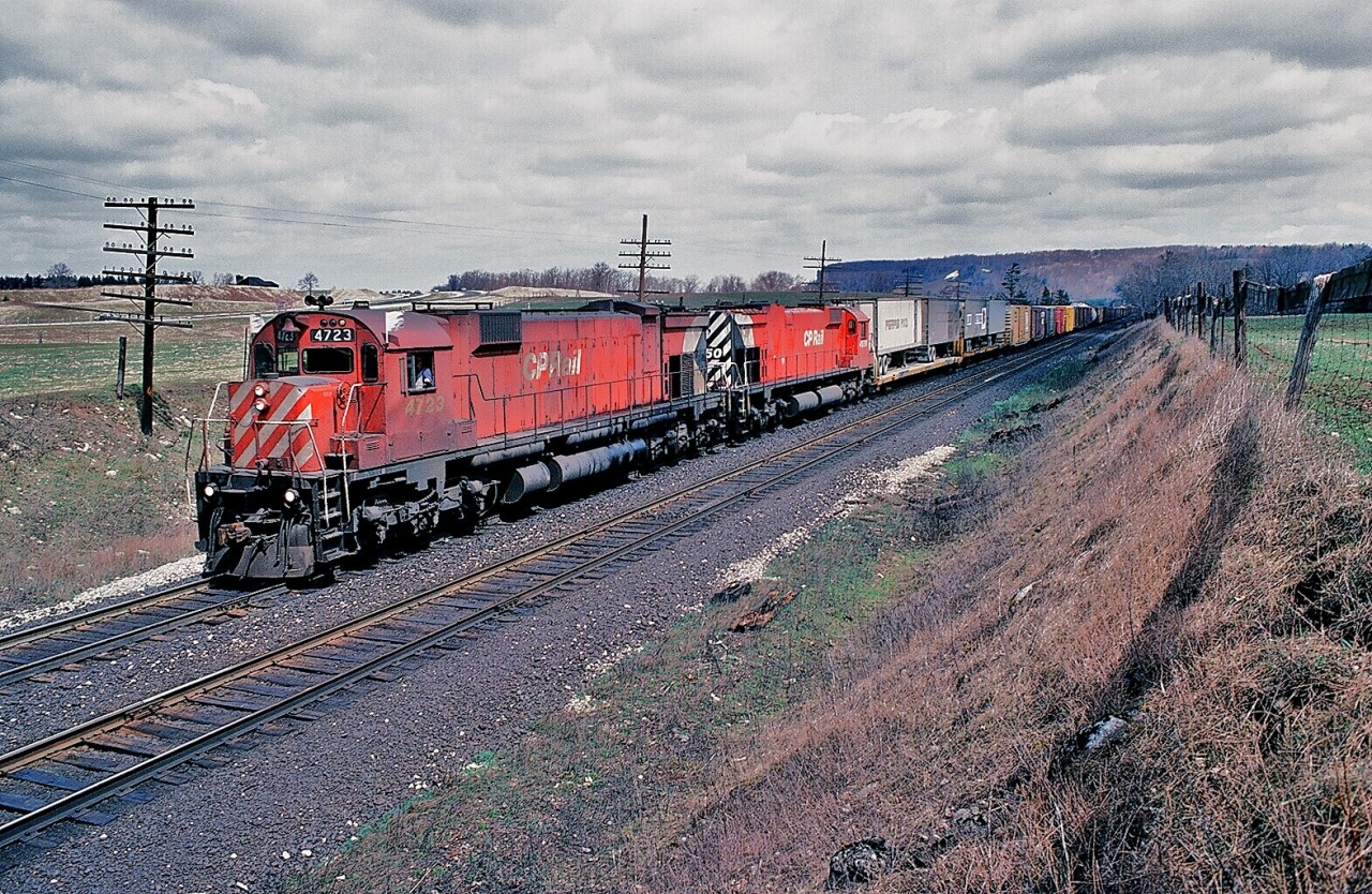 M for Magnificent, ( ...well, some of the time...)

On a cool, breezy and mainly cloudy early April 1980 Saturday a typical uninteresting Galt Subdivision afternoon, developed into an Alcophile's delight.

On the approach to Campbellville - on the grade up the Escarpment - CP Rail extra 4723 west ( with 4550 ) stalled when #4723 shut down. In a fleeting sunny break, here a silent M636 #4723 coasts by while M630 #4550 does all the work. First shot in the sequence of four, near Canyon Road. April 1980 Kodachrome by S.Danko.

 Big  M 's  at work :

  at Campbellville  


  the big M pushers  


 the biggest big M