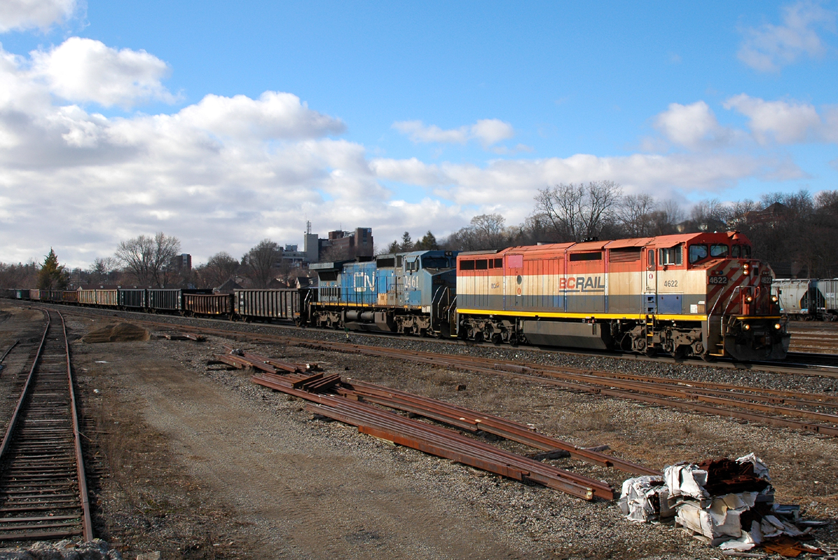 The clouds have parted briefly as 330 rolls downgrade past Brantford with BCOL 4622 - IC 2461