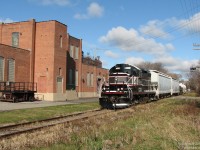 Passing by the location of a former rail customer long-gone (the building at the left once housed STP and Charters Publishing, who had a rail siding here), CCGX 4009 leads the twice-a-week Orangeville Brampton Railway interchange run from Orangeville to Streetsville, seen at McMurchy Avenue in Brampton on the southbound leg of the trip.
<br><br>
One thing to note is the locomotive and cars covered in snow from sitting in Orangeville up north, with nary a trace on the ground here in Brampton. Mother Nature works in mysterious ways.