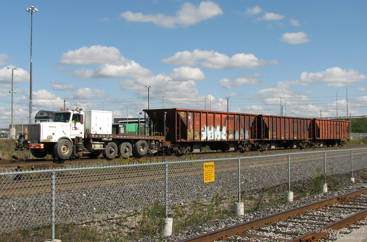 A Brandt hi-rail truck is a somewhat unusual sight, and this one was an interesting surprise while waiting for the afternoon GO train. Pushing 3 orange ballast hoppers, Western Star/Brandt Power Unit CN 179646 heads through Bramalea GO Station as work continues on triple tracking this section of CN's Halton Subdivision through Brampton.