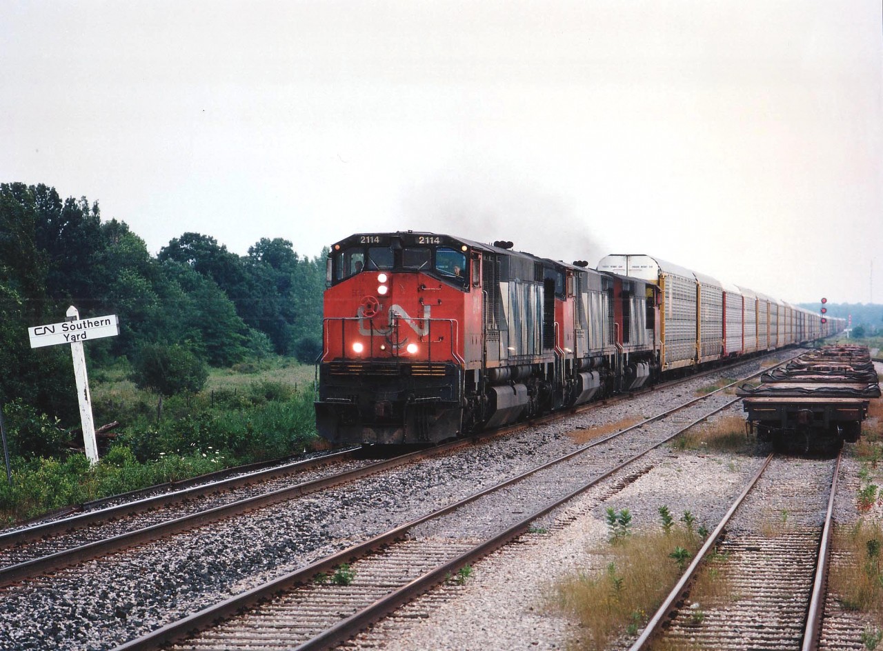 This was my only opportunity to shoot a trio of Bombardier HR616's in action. Perhaps because only 20 of them were ever built. Although this train would run right by St. Catharines where I was living in 1995, I knew it would be dark by the time it made St. C's station, so ventured up to Welland to meet it, and even there the daylight was sinking fast. Power on this train was CN 2114, 2113 and 2110. "HR" stood for 'high reliability', and these locomotives were anything but.  Built in 1982, they were all off the system by 1998, the first two shown sold to NRE and the last one retired.