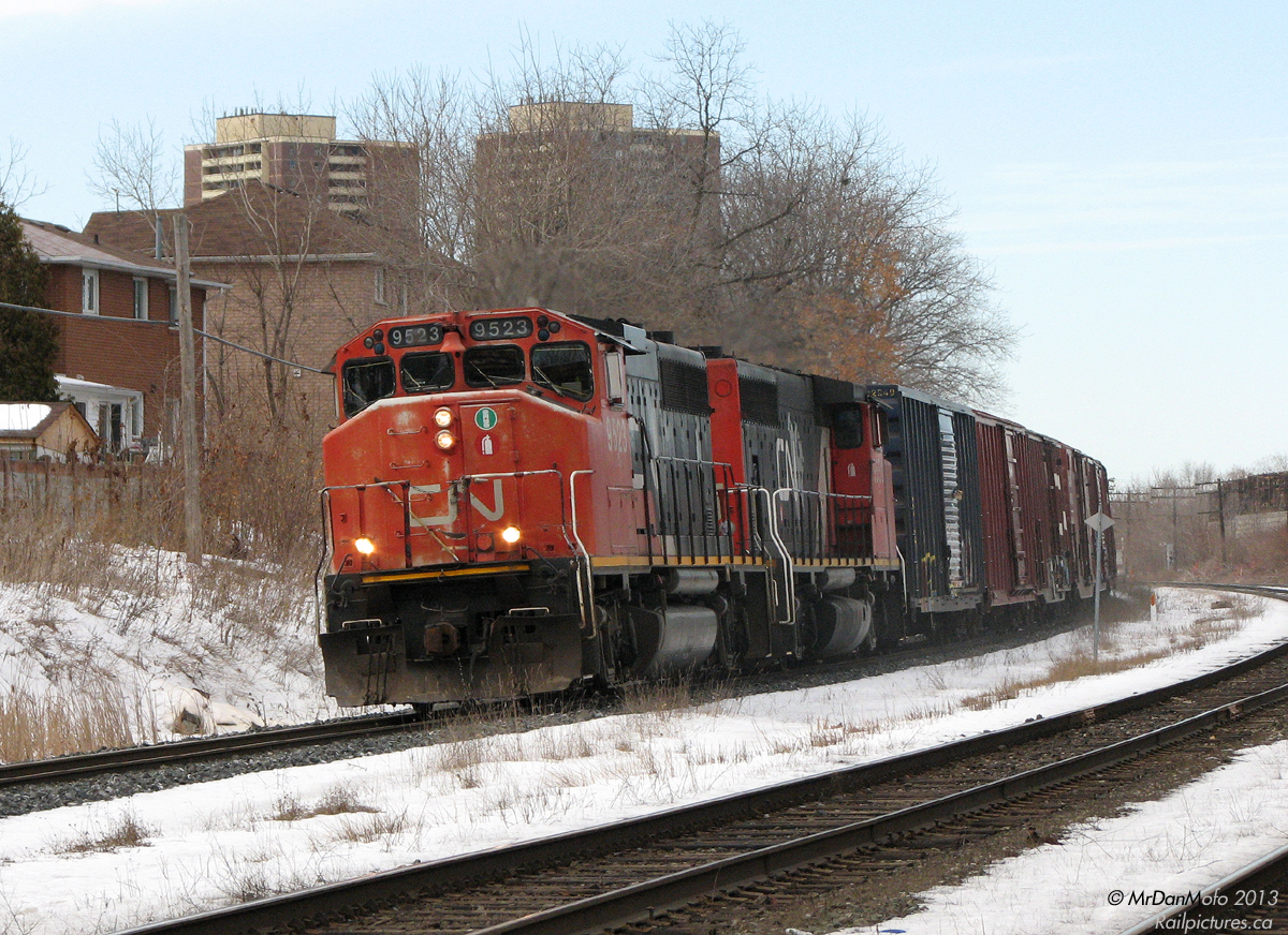 Naturally, one often takes liberties to get "that shot". Leaving Bramalea on the GO Train, CN #577 with a pair of GP40-2L(W) units were spotted ready to leave Malport and follow us down the single-track Weston Sub, on their way to interchange cars with CP at West Toronto. The only freights that used the line were afternoon transfer run #577 and the night switcher #579 (that only went as far as Etobicoke North though) I also had some time to kill, and an idea for a shot I wanted.

So, upon arrival at Weston GO Station, it was decided to trade off a quick ride downtown for a shot of #577 and TTC it the rest of the way. Hopping off the train at 12:31pm and walking up a block or two, it was a short wait of 8 minutes. Riding GO #260's block, CN #577 with 9523 and 9551 on point rounds the bend into the town of Weston ON with their short train.

Then I walked down Church St., and patiently waited for the next 89 Weston bus to Keele Subway Station. Back to your regular programming.