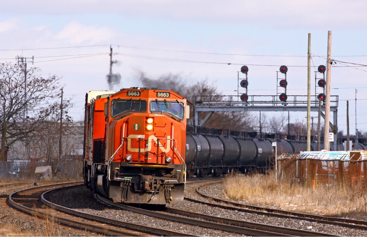 Running a little bit later than normal, CN 331 motors around the big curve just west of the plant at London East, with CN 5663-2449 in command. The track at right is Walker's siding, which becomes the Talbot spur and runs south to St. Thomas.
