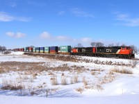 A pair of EMDs lead an eastbound intermodal towards Winnipeg.