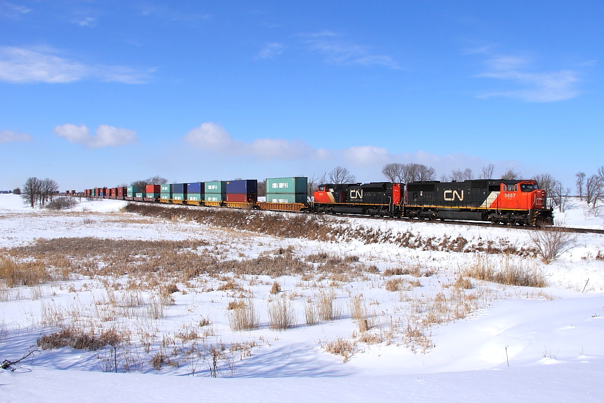 A pair of EMDs lead an eastbound intermodal towards Winnipeg.