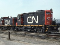 In something of a ‘BEFORE & AFTER’ staging, CN SW1200RS 7303 and SW1200RSm 7104 portray Pte. St. Charles’ effort to create a super switcher or ‘SWEEP’; SWitcher + gEEP. Between 1985 and 1987 CN’s rebuild facility created a total of eight (CN 7100 – 7107) SWEEP’s by combining a SW1200 frame cab and prime mover with the hood, main generator, cooling fans and traction motor blowers from donor GP9’s. All were sold to subsidiary CANAC in February 2000. Some of the SWEEP’s were subsequently conveyed to shortlines/industrial customers and remain in service to this day. CN 7104 was originally constructed as CN 1248 in 1956.