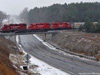 CP 3114, 3103, and 3057 lead KLR T08 over Simcoe Street North at Raglan through a late autumn snowfall. 1016hrs.