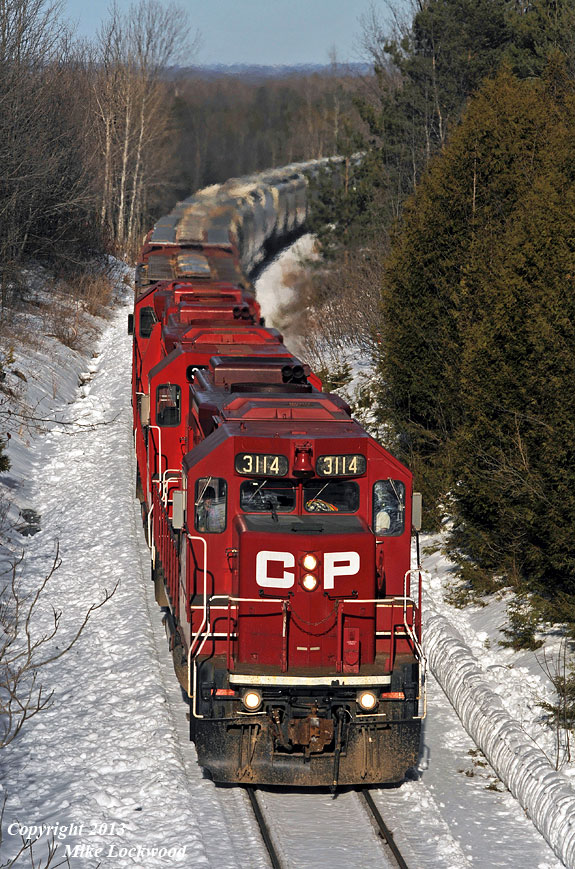 Well into the climb up Maryanne's Hill, CP 3114, 3103, and 3134 lead T07's 33 cars through the narrow cut at Tapley. 1602hrs.