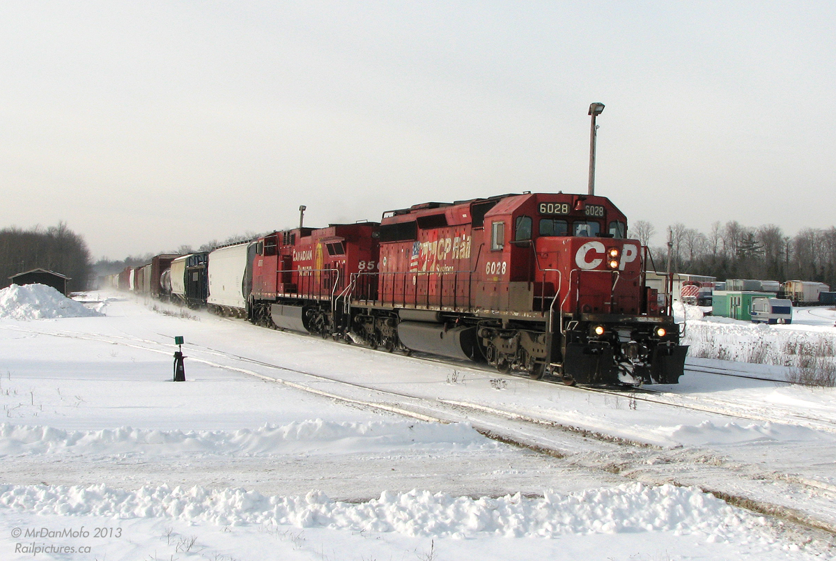 O Canada!

With the afternoon sun and bright clean snow really showing a contrast to the dirty red SD40-2 and slightly cleaner GE, CP 158 kicks up some white stuff cruising through Guelph Junction, past OSR's enginehouse and facilities. Happily there was a rather unique unit in the lead today: CP 6028 features the one-of-a-kind "Triple Flags" livery: someone added an extra Canadian flag onto the usual half-US half-Canadian flag logos on both sides of the unit. Coupled with the typical Canadian winter environment and beaver on the trailing unit, all that's missing in this shot is an igloo, a mountie and a dog-sled team!