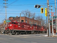 With work completed, CP8200 leads two other sisters back to Kinnear with 10 cars and are seen crossing Main and Gage on the belt line. 