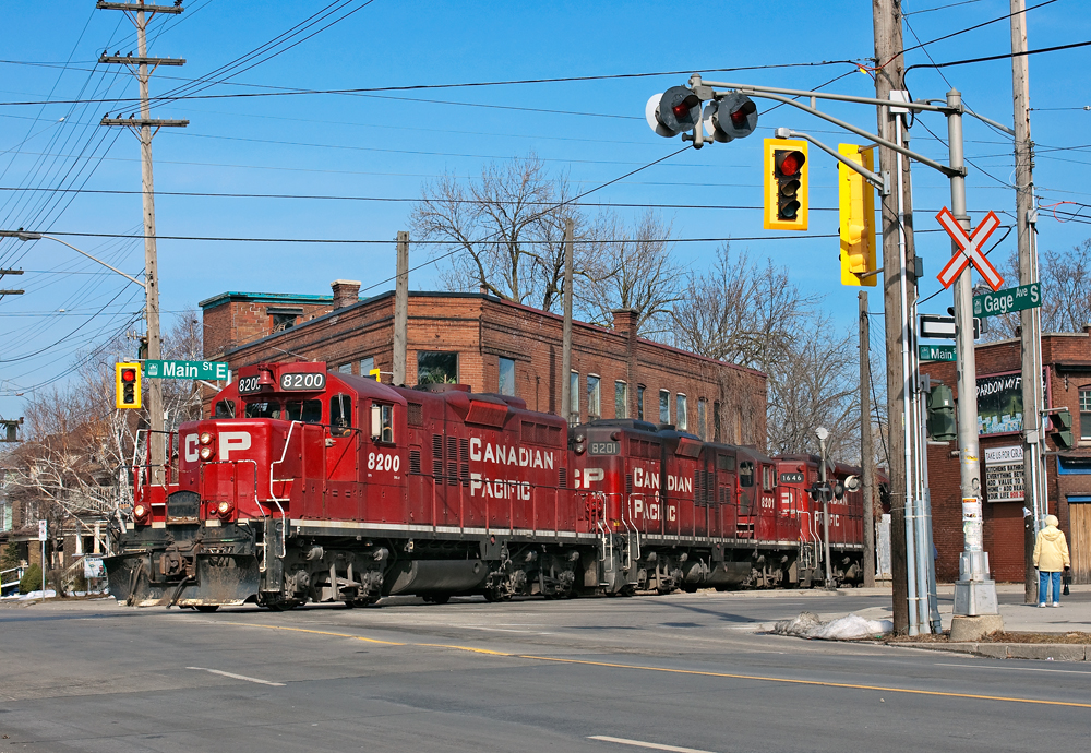 With work completed, CP8200 leads two other sisters back to Kinnear with 10 cars and are seen crossing Main and Gage on the belt line.