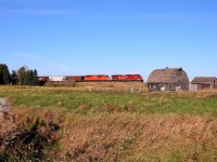 CP 8502 leads a red barn past the old farm at Esmond.